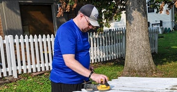 Chris Wehner sanding a piece of wood