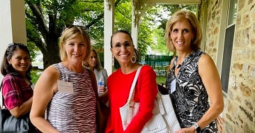 group of women smiling on a porch