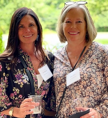 two women posing and smiling