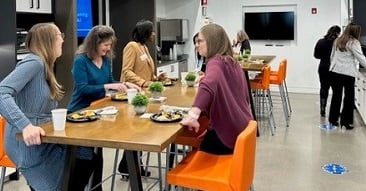 women enjoying breakfast in kitchen