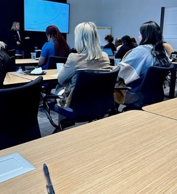women sitting in presentation