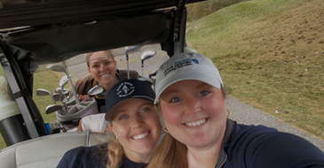 team members at golf tournament